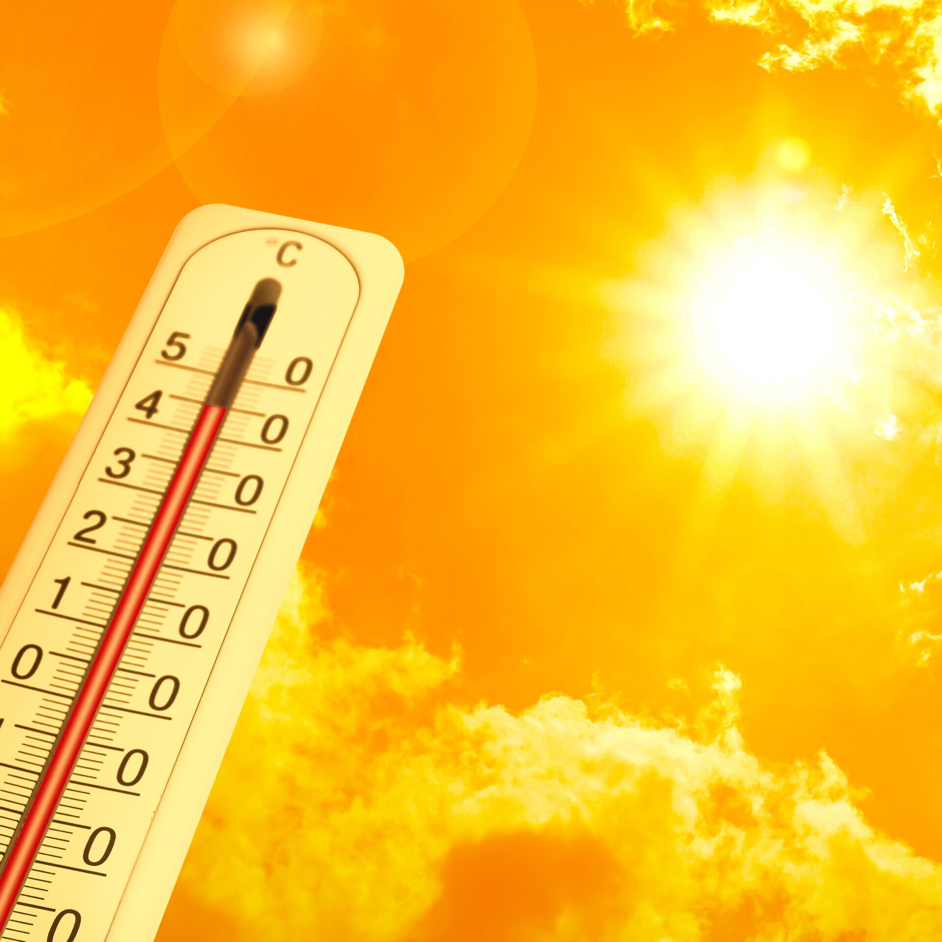 Extrem hohe Temperatur auf dem Thermometer vor orangefarbenem Himmel an einem sonnigen Tag.